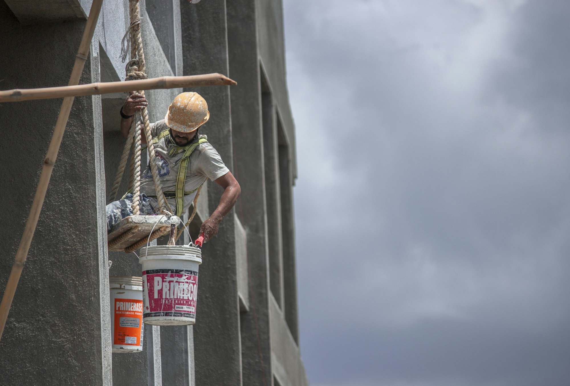 man-in-green-t-shirt-and-brown-hat-climbing-on-gray-concrete-wall-during-daytime.jpg man in green t-shirt and brown hat climbing on gray concrete wall during daytime